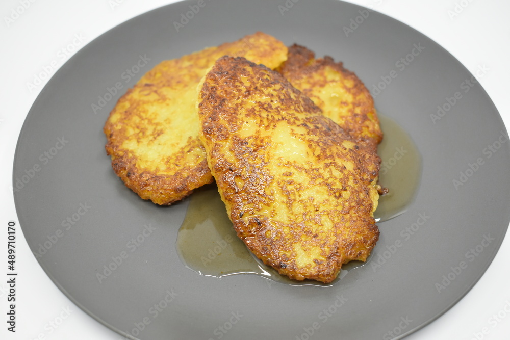 Pumpkin pancakes with apricot jam on a gray plate. Light background.