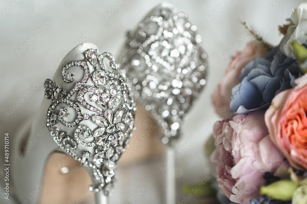 Brides wedding shoes with a bouquet with roses Brides wedding shoes with a bouquet with roses
