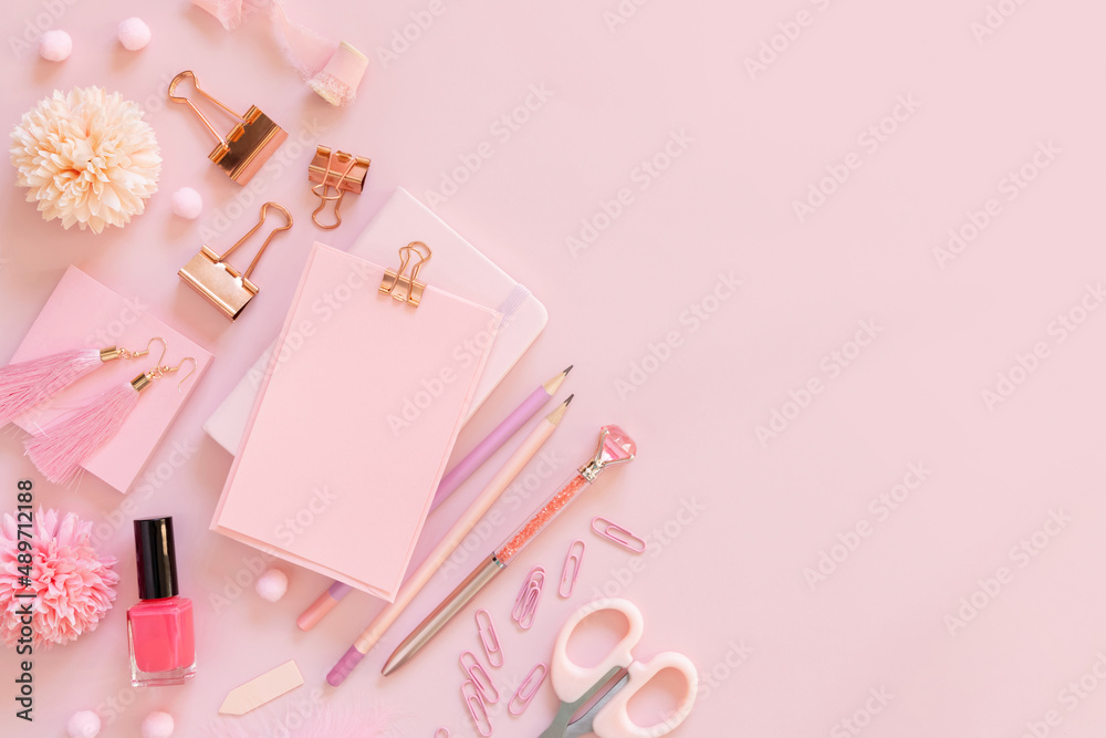 Paper with a clip and Pink girly accessories on pastel pink Top view, mockup Paper with a clip and Pink girly accessories on pastel pink Top view, mockup