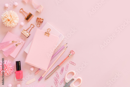 Paper with a clip and Pink girly accessories on pastel pink Top view, mockup