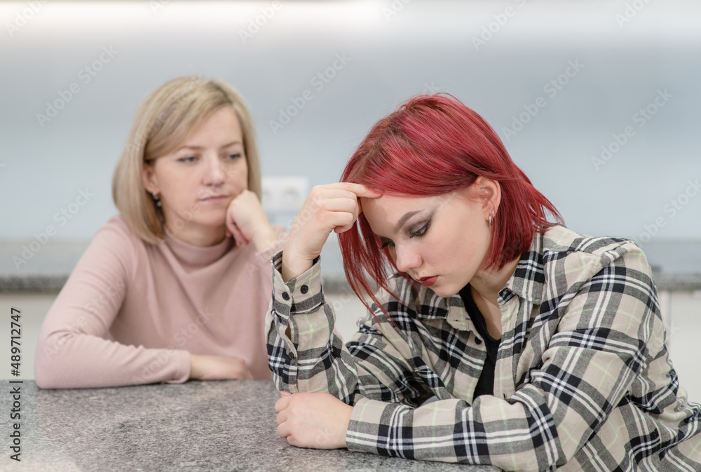 Family conflict. Unhappy mother and guilty daughter are offended at each other Family conflict. Unhappy mother and guilty daughter are offended at each other