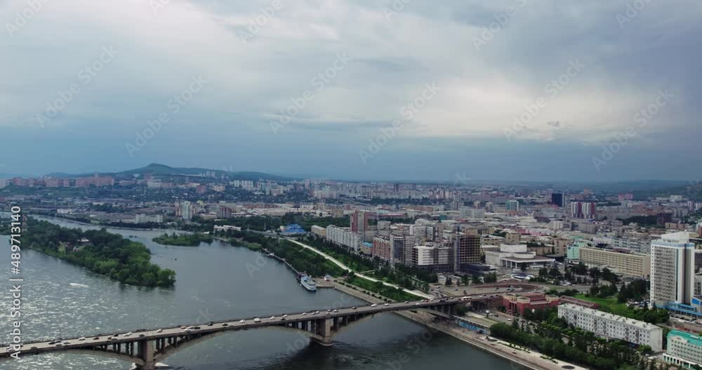 The city is on a wide river, view from a drone. The city is on a wide river, view from a drone.