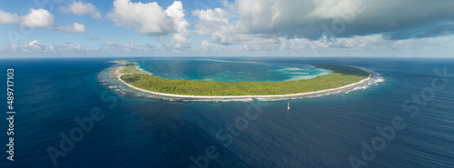 Aerial panorama of yacht and tropical Pacific Atoll photo