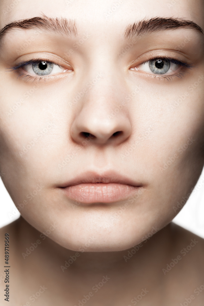 close up face studio portrait of a beautiful young woman against white backgroung close up face studio portrait of a beautiful young woman against white backgroung
