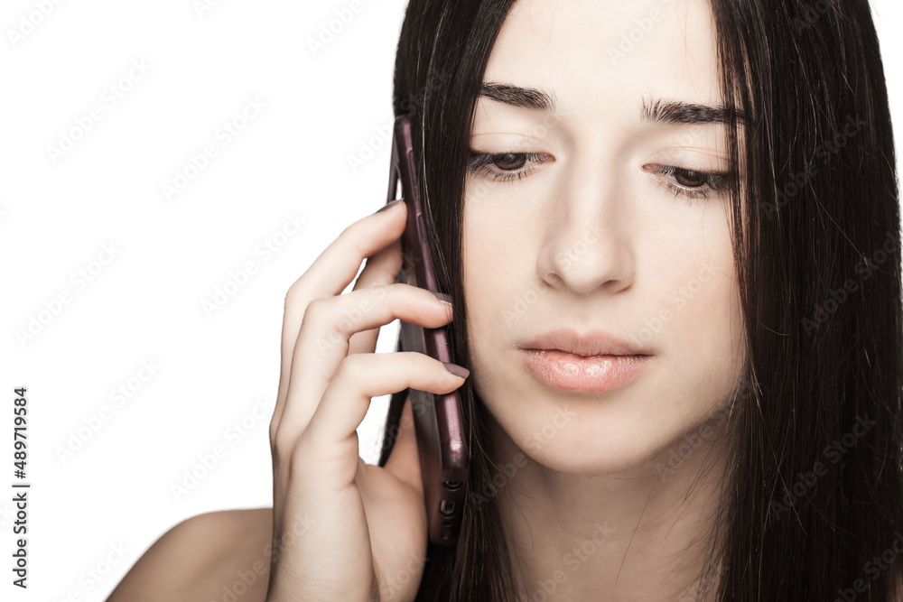 studio portrait of a beautiful brunette girl using phone against white backgroung. studio portrait of a beautiful brunette girl using phone against white backgroung.