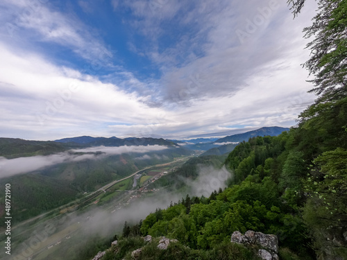 Scenic view from below mount Roethelstein near Mixnitz in Styria, Austria. Landscape of green alpine meadow and a small village in the valley of Grazer Bergland in Styria, Austria. After sunrise photo