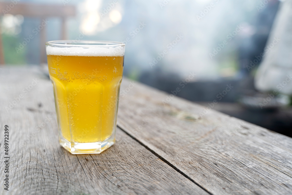 a glass of beer on the table in nature a glass of beer on the table in nature
