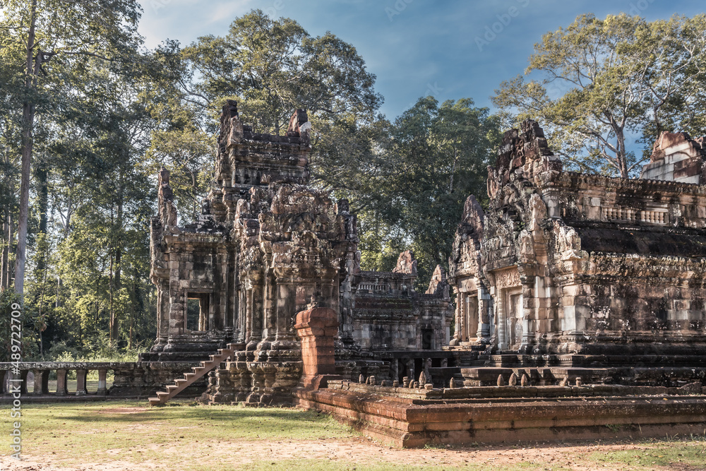 Ruins of ancient Cambodian temple among trees in Angkor complex, Siem Reap, Cambodia Ruins of ancient Cambodian temple among trees in Angkor complex, Siem Reap, Cambodia