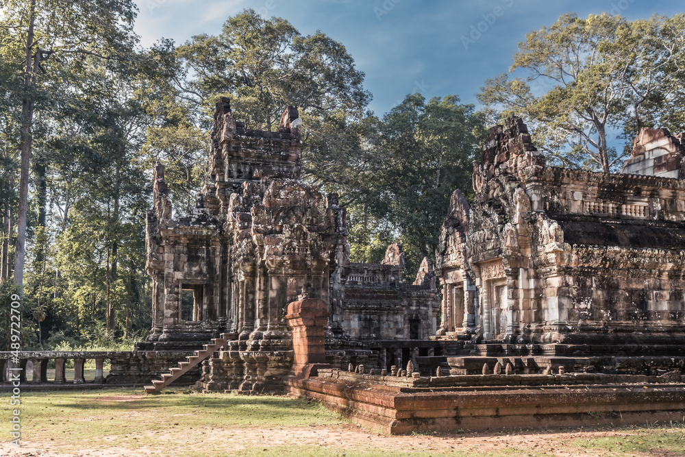 Ruins of ancient Cambodian temple among trees in Angkor complex, Siem Reap, Cambodia