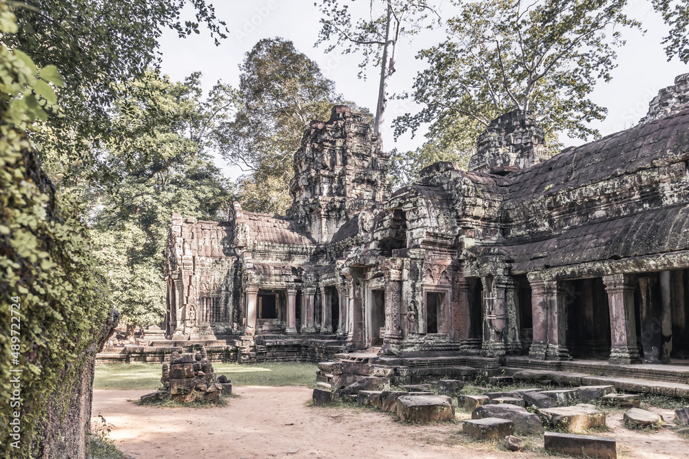 Ruins of ancient Cambodian temple among trees in Angkor complex, Siem Reap, Cambodia