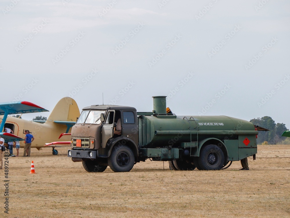 Fuel tanker refuels aircraft at the airport Stock Photo | Adobe Stock