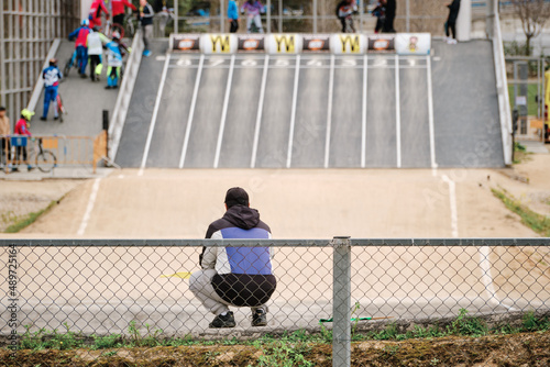 BMX competition. A judge supervises the start of the riders.