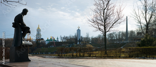 February 19, 2022. Kyiv, Ukraine. Monument to Bykov and Soviet soldiers pilots against the backdrop of the Lavra Bell Tower, the Holodomor Museum and the obelisk of eternal glory photo