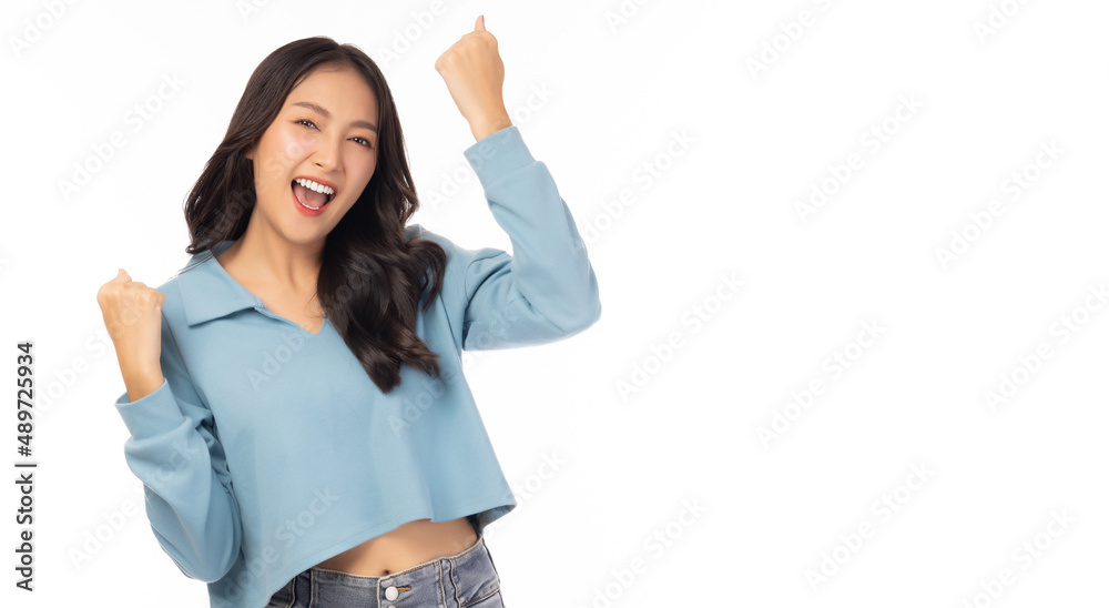 Excited young asian female with raised hands celebrating success ...