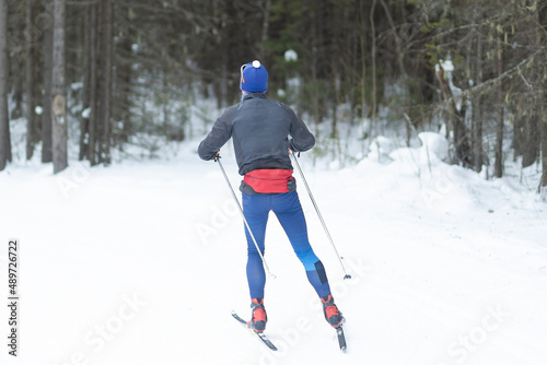 Cross country Skilling. A skier goes skiing on the ski track.