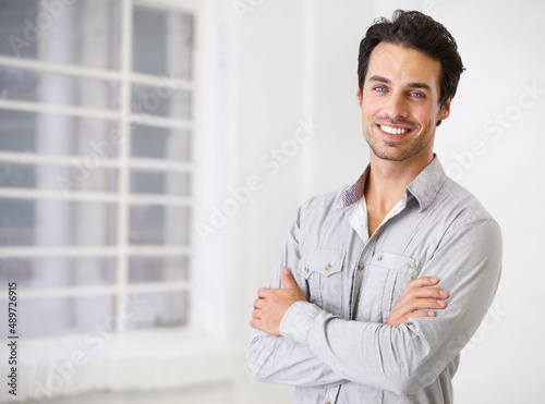 Free Download Confidence is infectious. Portrait of a smiling handsome man with his arms crossed. - GFXLoad