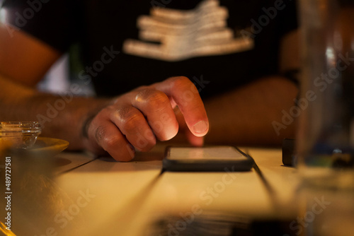 Man using mobile phone on the table