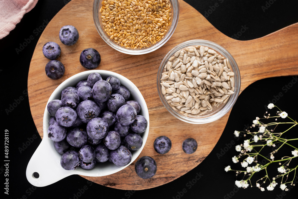 Bowl with fresh blueberries, sunflower seeds and flax seeds Bowl with fresh blueberries, sunflower seeds and flax seeds