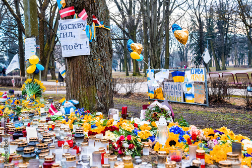 Thousands candles and flowers standing on the street during the war in Ukraine photo