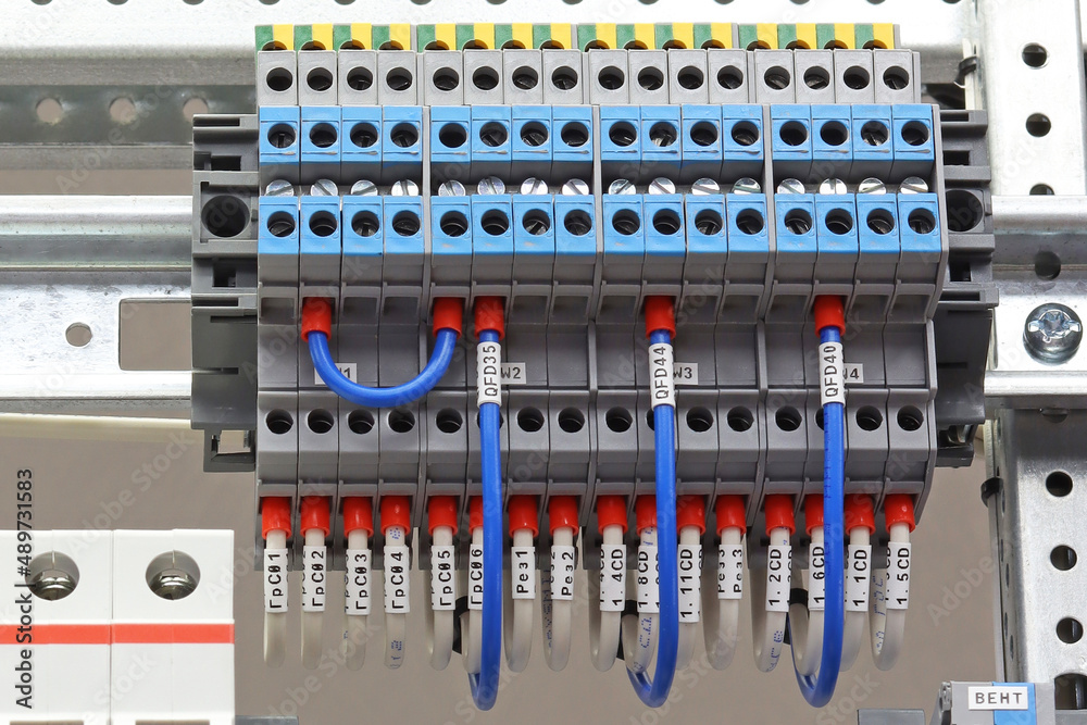 Connecting colored mounting wires to the electrical terminals on the control panel.