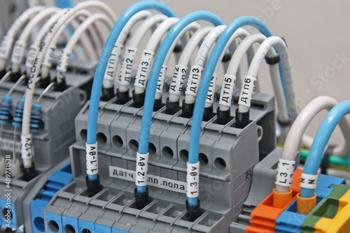 Connecting colored mounting wires to the electrical terminals on the control panel.