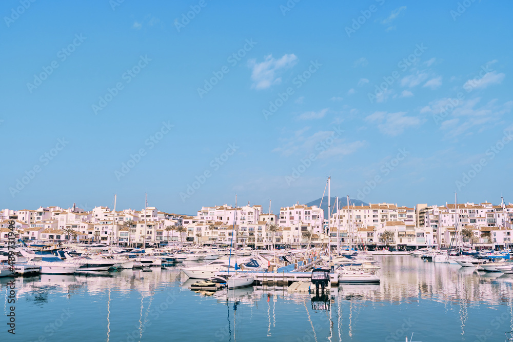 Puerto Banus, Marbella 25 de febrero de 2022, View of Puerto Banus marina with boats and white houses in Marbella town at sunrise, Andalusia, Spain Puerto Banus, Marbella 25 de febrero de 2022, View of Puerto Banus marina with boats and white houses in Marbella town at sunrise, Andalusia, Spain
