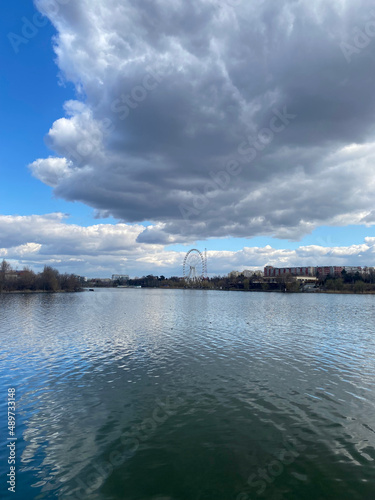Lake with city and clouds reflections portrait view of