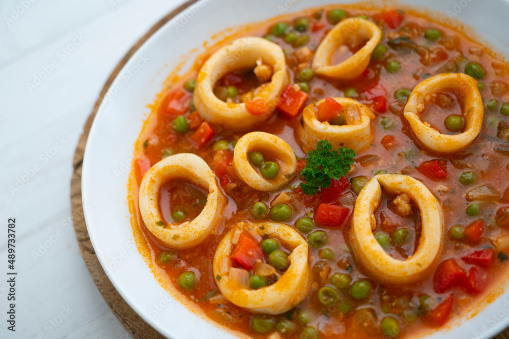 Squid stew, red pepper and peas. Spanish traditional tapas. Squid stew, red pepper and peas. Spanish traditional tapas.