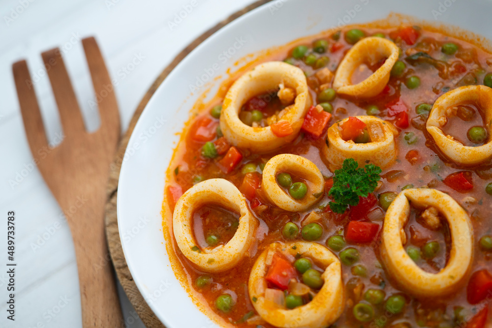 Squid stew, red pepper and peas. Spanish traditional tapas. Squid stew, red pepper and peas. Spanish traditional tapas.