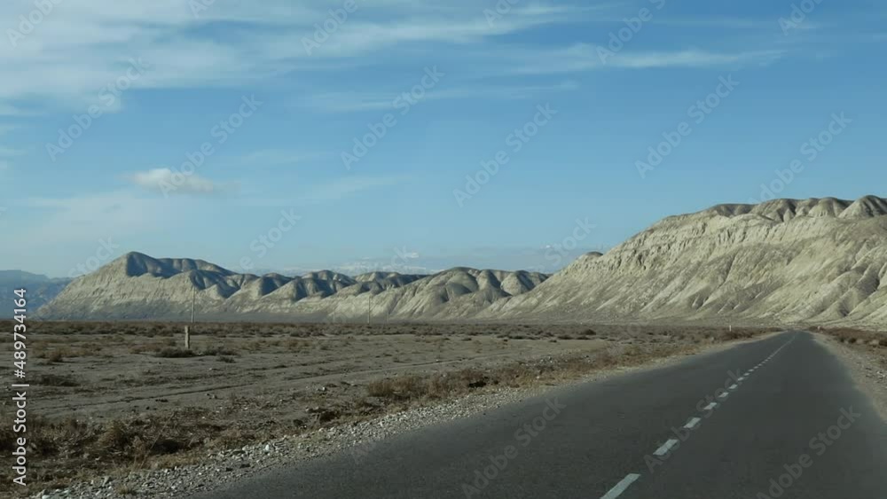 Empty mountain road on a sunny day view from a car's front seat Empty mountain road on a sunny day view from a car's front seat