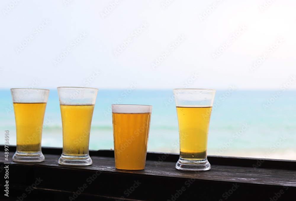 cold beer in glasses against the blue ocean and sky cold beer in glasses against the blue ocean and sky