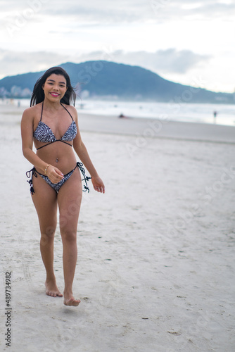 young beautiful and happy Asian Indonesian woman in bikini enjoying  holidays at tropical beach in Bali enjoying holidays and travel Stock Photo