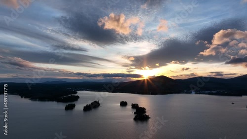 Sun setting behind mountain on Moosehead lake Aerial photo