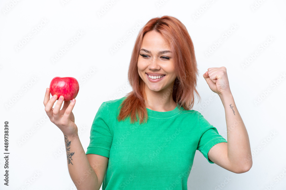 Young Russian girl with an apple isolated on white background celebrating a victory
