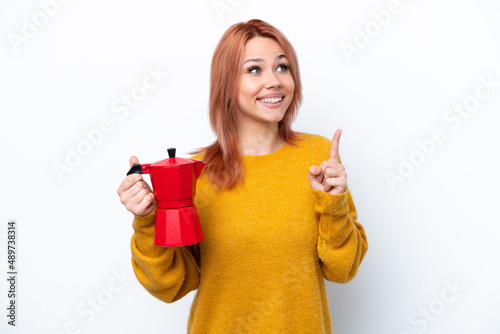 Young Russian girl holding coffee pot isolated on white background intending to realizes the solution while lifting a finger up