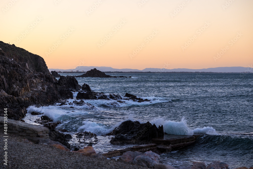 Coucher de soleil sur les vagues se fracassant sur les rochers au pied de Collioure (Occitanie, France) Coucher de soleil sur les vagues se fracassant sur les rochers au pied de Collioure (Occitanie, France)