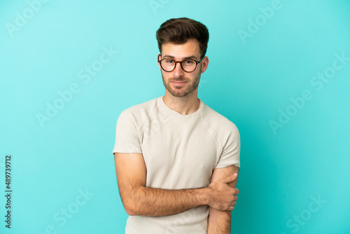 Young caucasian handsome man isolated on blue background laughing