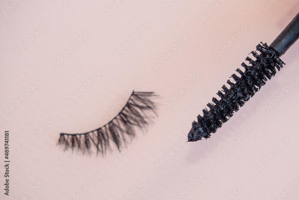Fake eyelashes on pastel pink background. Beauty concept. Makeup cosmetics. Top view, flat lay. Layout. Place for text and design. Web Banner. Minimal style Fake eyelashes on pastel pink background. Beauty concept. Makeup cosmetics. Top view, flat lay. Layout. Place for text and design. Web Banner. Minimal style