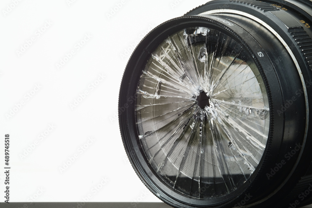 Fototapeta premium Broken camera lens isolated on a white background