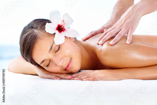 Lost in spa bliss. Gorgeous young woman relaxing during a spa massage.