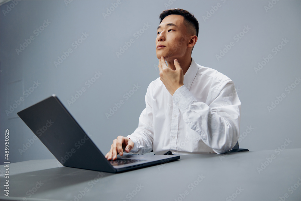 manager working on a laptop sitting at a table in the office executive manager working on a laptop sitting at a table in the office executive