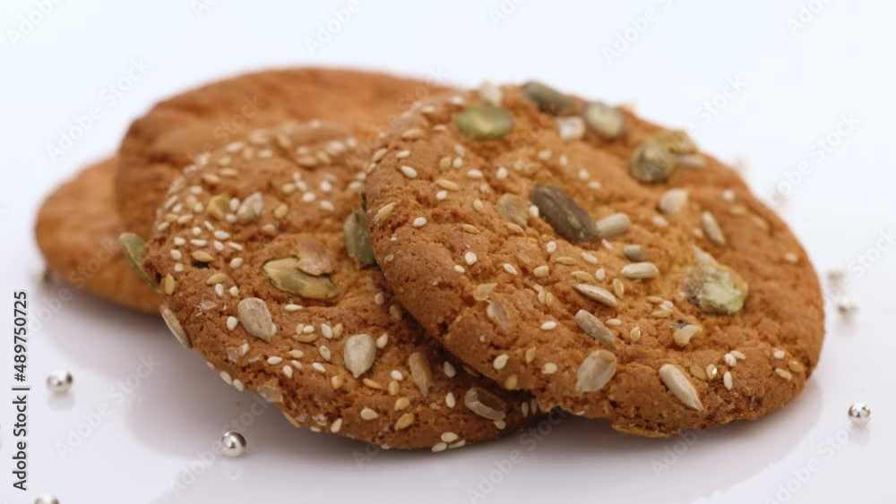Eat oatmeal cookies. Stack of whole meal cookies on white background. Wheat fall on dietary cookies. Eat oatmeal cookies. Stack of whole meal cookies on white background. Wheat fall on dietary cookies.