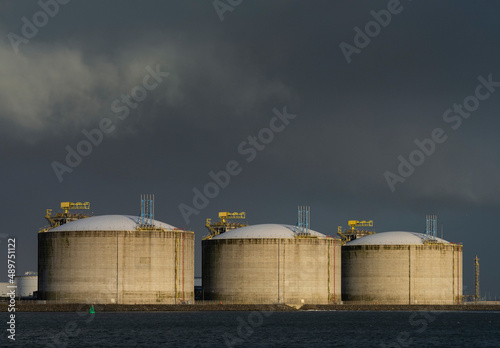 Liquefied Natural Gas (LNG) storage tanks at harbour photo