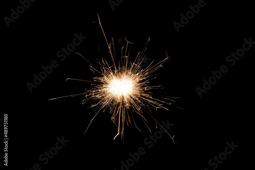 Burning sparkler isolated on black background. Fireworks theme. Light effect and texture. © Jozsef