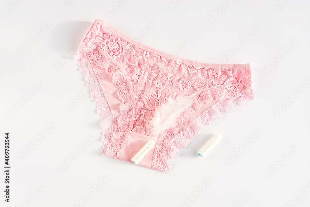 Women's underwear and menstrual intimate hygiene products. Concept of menstruation, woman's health, menstrual cycle. Critical days, pain, gynecology, female diseases, premenstrual syndrome. Top view Women's underwear and menstrual intimate hygiene products. Concept of menstruation, woman's health, menstrual cycle. Critical days, pain, gynecology, female diseases, premenstrual syndrome. Top view
