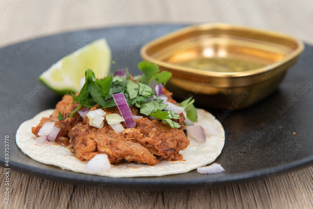 Eastern flavored chicken tikka taco served as an appetizer to eat before your meal