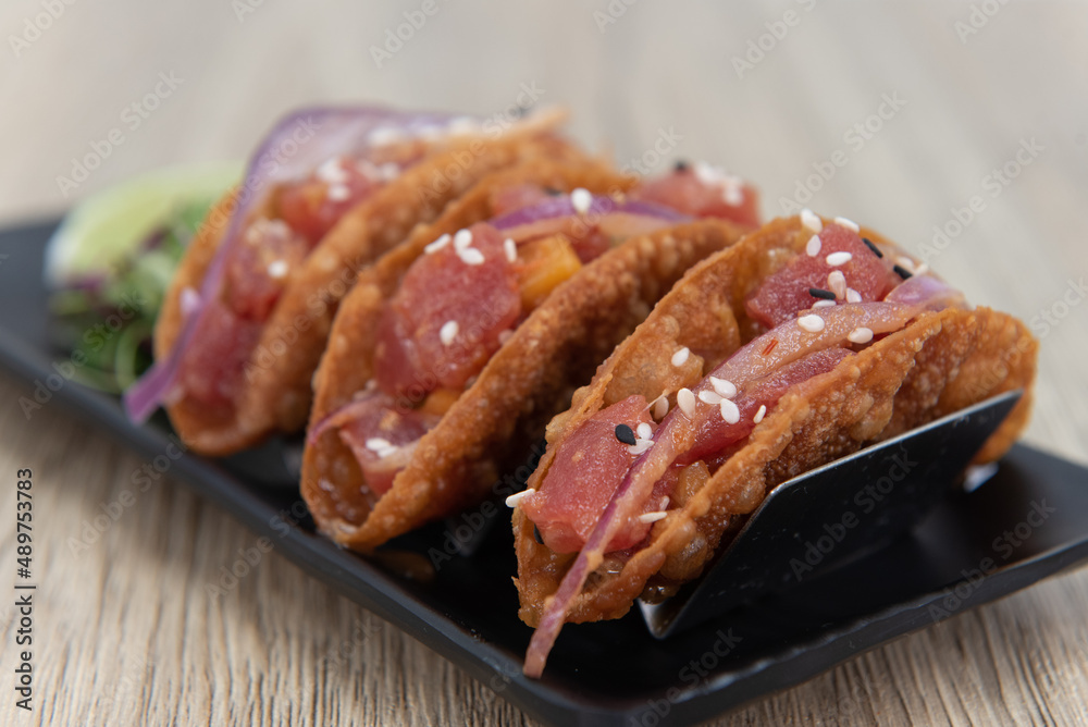 Tasty appetizer of ahi poke tacos in a crispy shell to eat before your meal Tasty appetizer of ahi poke tacos in a crispy shell to eat before your meal