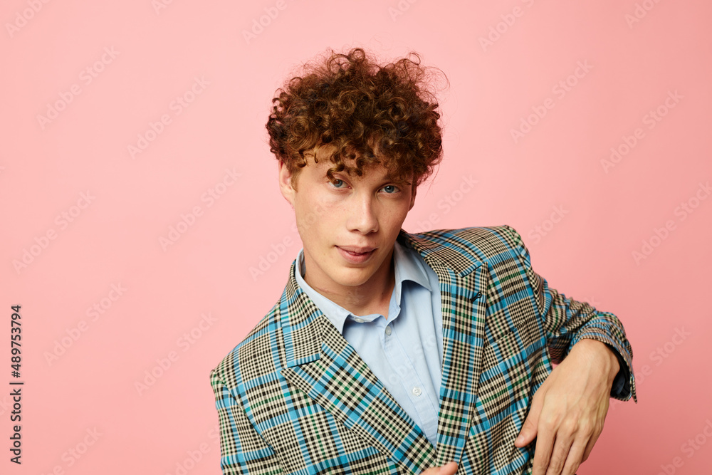 Young curly-haired man checkered blazer elegant style posing fashion isolated background unaltered Young curly-haired man checkered blazer elegant style posing fashion isolated background unaltered