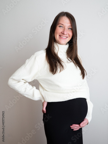 Portrait of beautiful and sexy pregnant young woman in dress. Mothers Day Holiday concept. vertical 