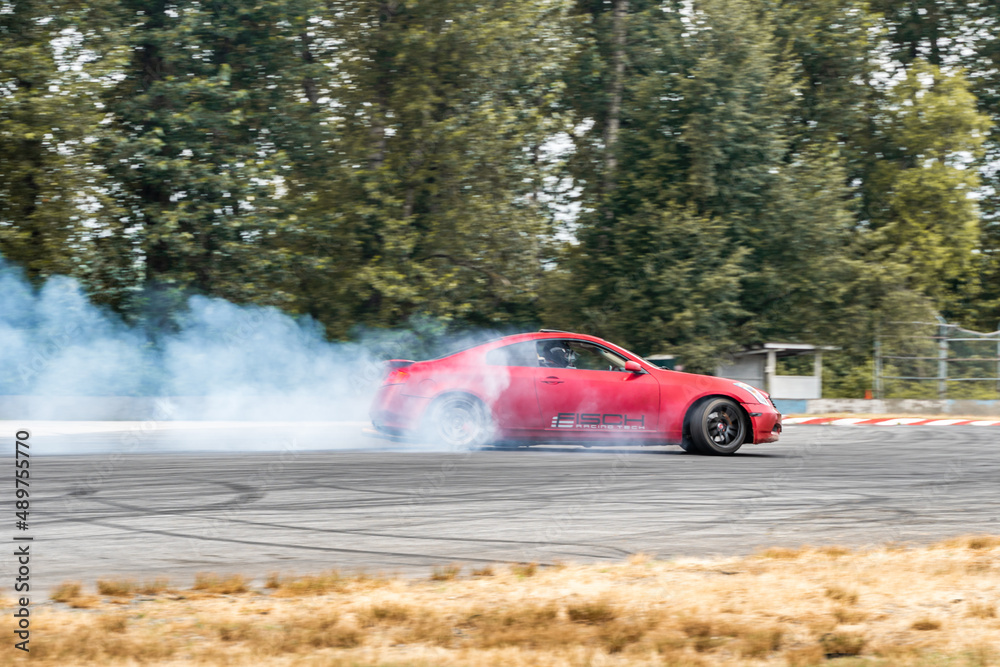 Red Drift Car / Race car drifting around corner very fast with lots of